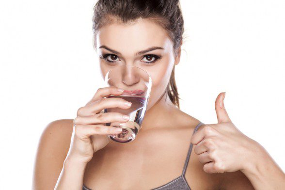 Woman Drinking Water Gives Thumbs up